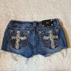 Miss Me Dark Blue Distressed Denim Cutoff Shorts. Cross back pockets.